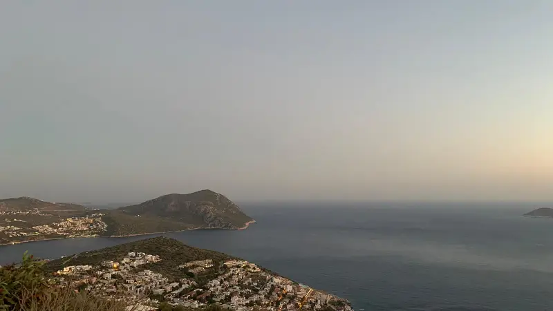 a picture taken on the top of a mountain seeing an endless sea view and some islands