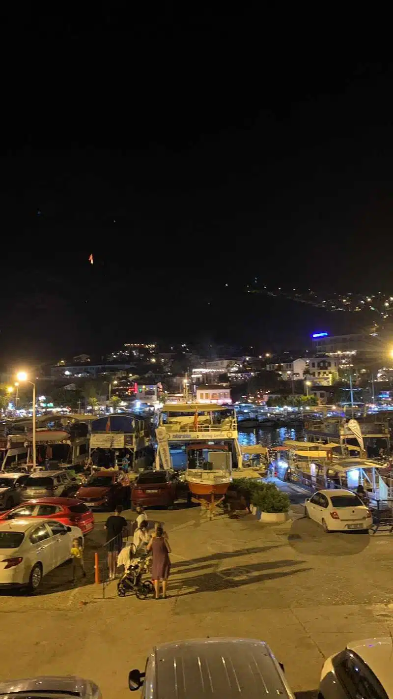 night view of Kas town in Antalya, lights are shiny and there are little boats on the sea